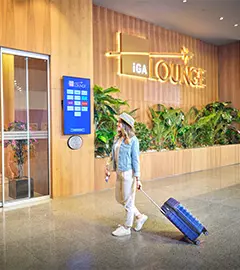 a passenger walking towards lounge in istanbul airport with her luggage