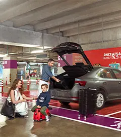 a family getting their baggages from their rental car