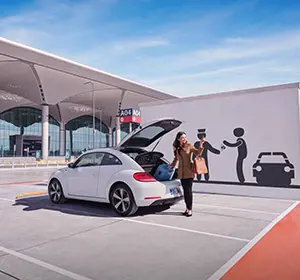a passenger getting her luggage from her car in istanbul airport carpark